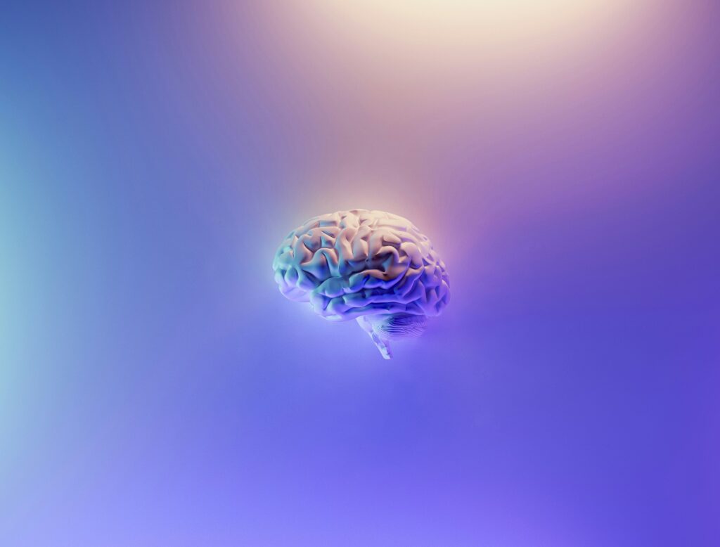 Illustration of a human brain glowing against a blue and purple gradient