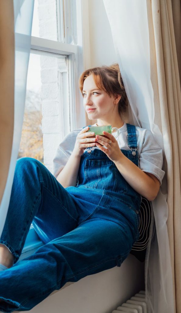 A woman sitting with a cup of tea in an intensive outpatient program
