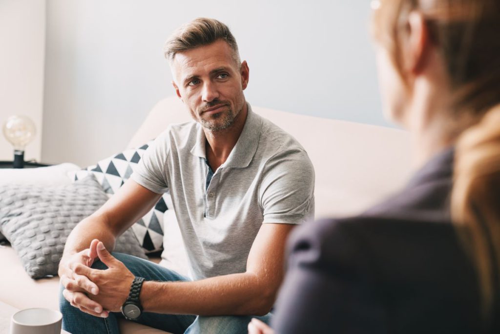 A man addicted to prescription drugs getting help by a professional